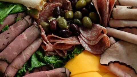 Close up top down view of sliced meat, cheese and olives Stock Photos