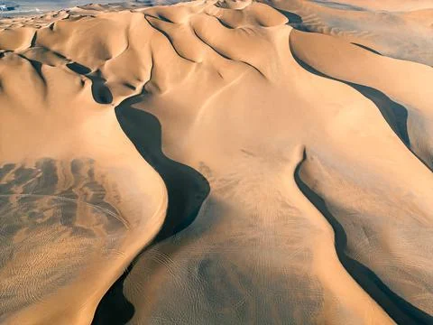 Close up top drone view on the sand hill during the sunset, Kumtag desert w.. Stock Photos