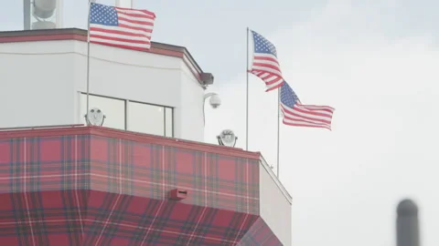 Close up of top of Hilton Head lighthouse with flags in wind in slow motion Stock Footage 204775218