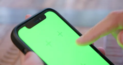 Close-up of top of iPhone screen being tapped and swiped, with green Stock Footage 230120564