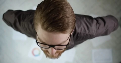 Close-up top portrait of the young attractive businessman with red beard and Stock Footage 82690153