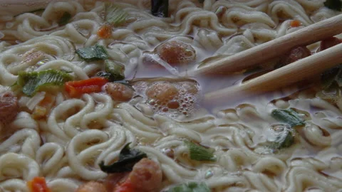 Close up of top ramen. Boiled instant noodle with Chinese chopsticks Stock Footage 149223996
