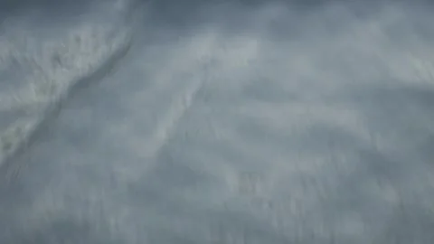 Close-up top shot of a cold waves splashing on the black sand shore Stock Footage 248203690