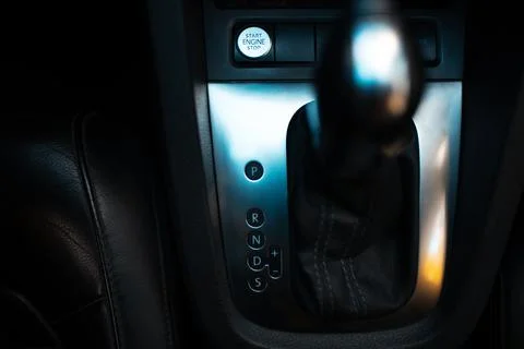 Close-up top view of automatic gearbox selector. Dark photo. Stock Photos