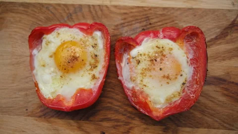 Close up top view of baked red peppers with cheese and eggs on wooden board Stock Footage 271628838