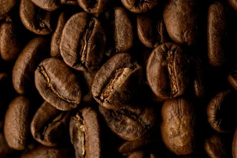 Close-up top view of beautiful composition of aromatic dark roasted coffee beans Stock Photos