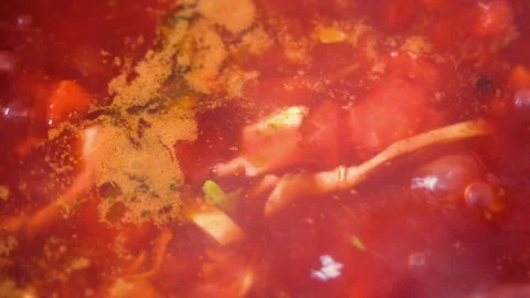 Close up top view on boiling tasty and juicy red borsch or beet soup in saucepan Stock Footage 240561877