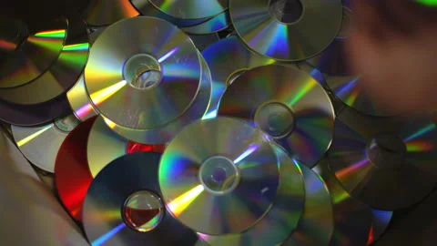 Close-up top view CD-ROM discs falling in box in slow motion. Closeup trash for Video stock 248972560