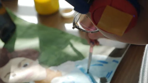 Close-up top view of a child paints a picture, drawing. Child development and Stock Footage 164107465