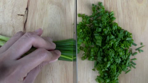 Close up top view chopping Spring onion with woman's hands Видео 136352002