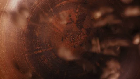 Close-Up, Top View Coffee Beans Fall into a Clay Plate Stock Footage 99129597