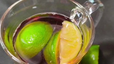 Close up top view of cold iced nestea drink inside a glass cup mug with jui.. Video stock 318127521