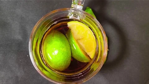 Close up top view of cold iced nestea drink inside a glass cup mug with jui.. Video stock 318127635