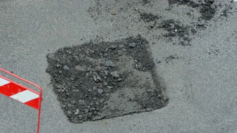 Close-up top view of destroyed part of road being casted with cement solution Stock Footage 139301289