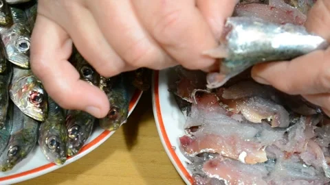Close-up top view of female hands cleaning fresh sardines fish on fillet. Stock Footage 150765122