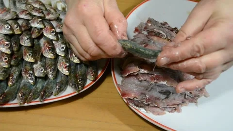 Close-up top view of female hands cleaning fresh sardines fish on fillet Stock Footage 150866090