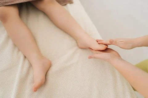 Close-up top view of five year old boy lying on massage table having lymphatic Stock Photos