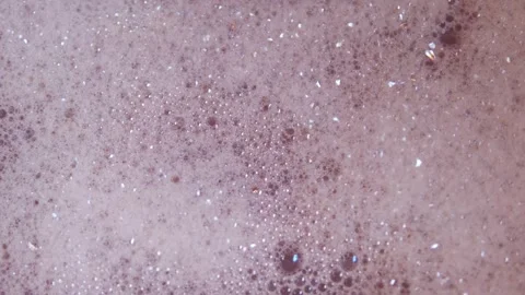 Close up top view of foam and soapy bubbles on a moving water surface, self Stock Footage 307592296
