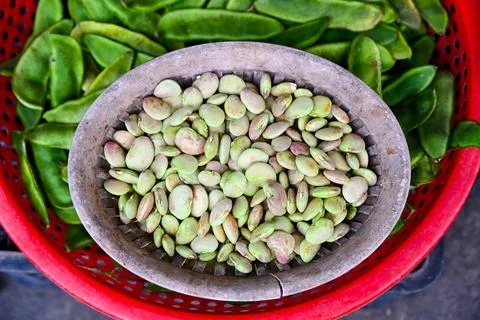 A close up top view of fresh raw lima beans in a wicker basket with green p.. Stock Photos