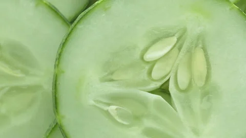 Close-up Top view of fresh sliced cucumber rotation Video stock 130766535