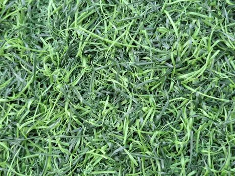 Close-up top view of green artificial grass plastic mat texture Stock Photos