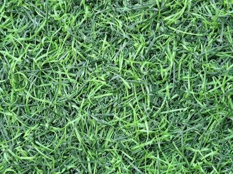 Close-up top view of green artificial grass plastic mat texture Stock Photos