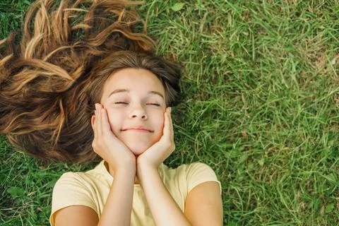 Close up top view high angle photo beautiful young girl child dreamily closed 库存照片