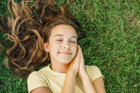 Close up top view high angle photo beautiful young girl child dreamily closed 库存照片