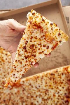 Close up top view image of a caucasian woman holding a slice of fresh cheese  Stock Photos
