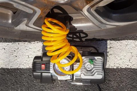 Close up top view image of a small 12 v air compressor attached to the stem v Stock Photos