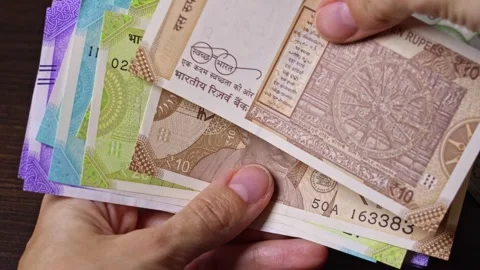 Close-up top view of Indian paper notes of 10 rupees Stock Footage 304090101