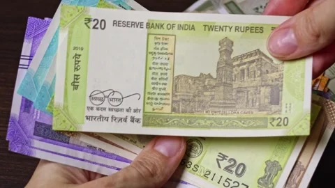 Close-up top view of Indian paper notes of 20 rupees Stock Footage 304090114