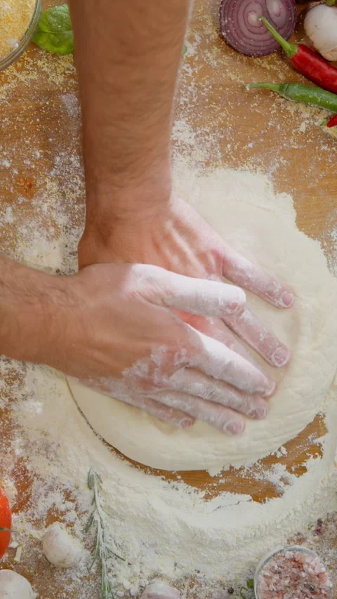 Close up top view of male hands kneading dough on floured wooden table with.. Stock Footage 337523541