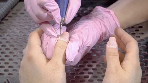 Close up top view manicurist remove cuticles using electric file nail drill Stock Footage 104057689
