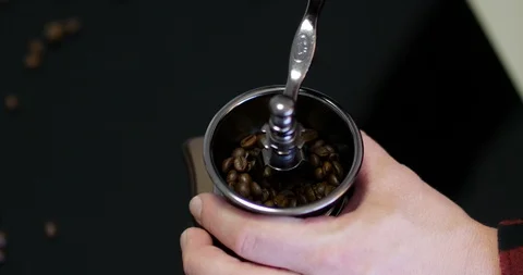 Close up top view of man's hands grinding coffee with an old design grinder.  Stock Footage 104405137