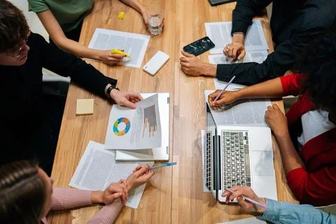 Close-up top view of multiethnic startup business team meeting present, investor Stock Photos