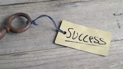 Close up top view of old key to success concept with label or tag. Pan movement Stock Footage 71905762