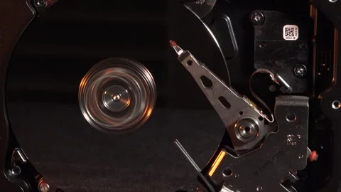 Close-up top view of an open spinning hard drive, with yellow lighting effec Stock Footage 320837030
