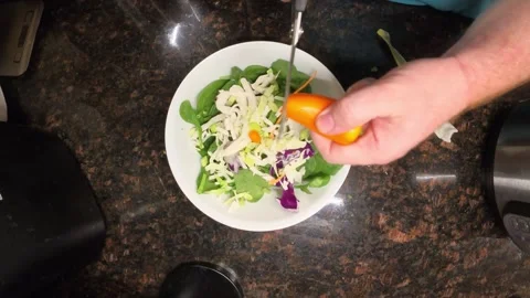 Close up top view of person cutting orange bell pepper with scissors on fresh Video stock 321498040