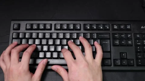 Close up top view of person typing on black computer keyboard at desk Stock Footage 342326962