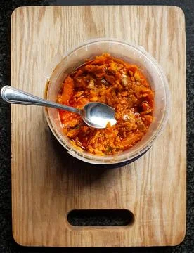 Close up top view on a plastic bucket container filled with spicy mango achar Stock Photos