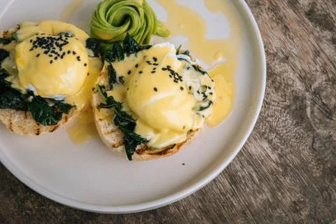 Close up top view Poached Egg with spinach, avocado and Bread Toast on wooden Stock Photos