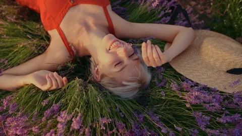 Close up top view portrait of young happy smiling girl sniffing flower, posing Stock Footage 115740944