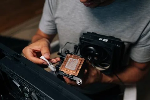 Close-up top view of precise computer maintenance involving cleaning processor Stock Photos