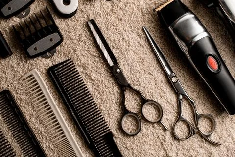 Close-up top view on professional scissors, combs, hair brushes and hair clips Stock-Fotos