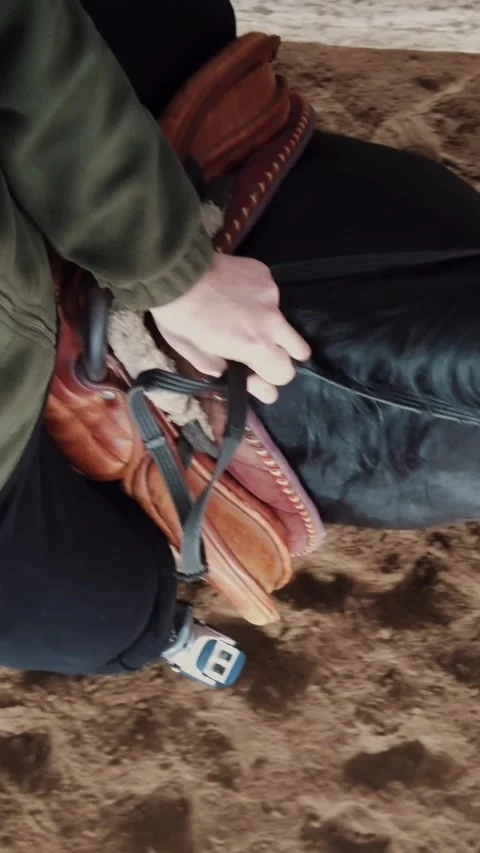 Close-up, top view, prosthetic leg of a man sitting astride a horse. Stock Footage 319016557