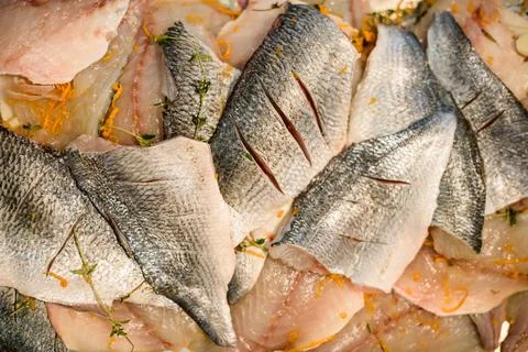 Close-up top view of raw fish fillet slices with spices. Preparation for cooking 스톡 사진