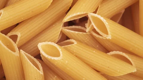 Close up top view of raw fresh pasta rotate in circle. Penne macaroni Stock Footage 284617254