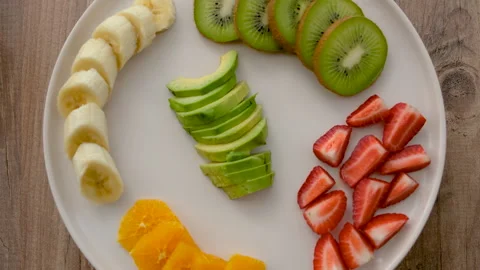 Close-up top view of rotating fruit plate Stock Footage 272290783