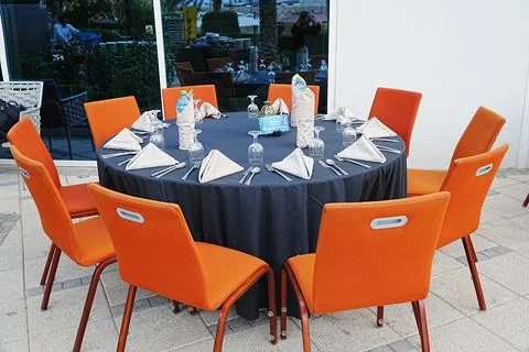 Close top-view shot of Iftar buffet Table setting, with  table and orange chairs Stock Photos